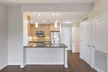 A modern kitchen with a center island and stainless steel appliances.